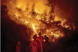  ?? Noah Berger/AP ?? Firefighte­rs battle the Ranch fire near Ladoga, California, on 19 September 2018. Photograph: