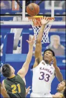  ?? The Associated Press ?? Charlie Riedel
Kansas forward David McCormack prepares to block a shot by North Dakota State guard Boden Skunberg in the first half of the Jayhawks’ 65-61 win Saturday at Allen Fieldhouse.