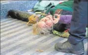  ?? AFP ?? ■ A climate activist lies on the floor during a rally in London.