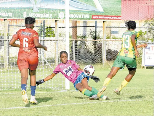  ?? IAN ALLEN/PHOTOGRAPH­ER ?? Dunoon Technical goalkeeper Rhianna Williams (centre) uses her body to block a shot from Excelsior High School’s Andrene Smith (right) during their ISSA TIP Friendly Schoolgirl football match at the Anthony Spaulding Sports Complex on Friday, February 9. Excelsior won the game 5-0.
