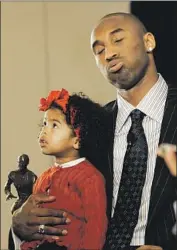  ?? Lori Shepler Los Angeles Times ?? G I A N NA sits on her dad’s lap at a news conference May 6, 2008, in Los Angeles in which Bryant was named the NBA’s most valuable player that season.