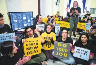  ?? J. Scott Applewhite / Associated Press ?? Environmen­tal activists occupy the Washington office of House Democratic Leader Nancy Pelosi of San Francisco. Activists are seeking to elevate the issue of global warming.