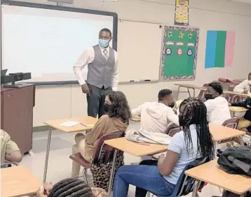  ?? SCOTT TRAVIS/SOUTH FLORIDA SUN SENTINEL ?? Carl Richardson teaches pre-algebra to students at Lauderdale Lakes Middle. The school saw large drops in math scores during the pandemic.