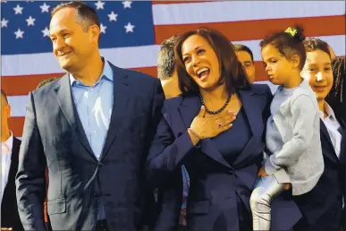  ?? JIM WILSON — THE NEW YORK TIMES ?? Sen. Kamala Harris, who will be sworn in today as vice president, is joined by her husband, Doug Emhoff, in Oakland in 2019. Harris is holding her niece Amara Ajagu.