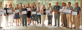  ?? CHRIS BARBER — DIGITAL FIRST MEDIA ?? Recipients of Kneale Dockstader grants line up with their check presentati­ons at ChesLen reserve on Thursday.