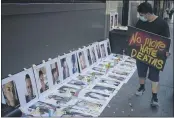  ?? DAMIAN DOVARGANES — THE ASSOCIATED PRESS FILE ?? Members of the LGBTQ community remember victims of Florida’s Pulse nightclub massacre, as they hold a candle light vigil in downtown Los Angeles.