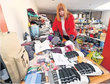  ?? ?? Generous Volunteer Shirley Greig looks through the donations which have been handed in