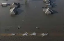  ?? GERALD HERBERT, THE ASSOCIATED PRESS ?? Cars proceed cautiously through flooded streets in Orange, Tex., Thursday in the flooded wake of Harvey.