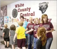  ?? ANGELA SPENCER/THREE RIVERS EDITION ?? From left are Paula Cleveland, Connie Miller, Tonia Piker and Debbie Stanley. The employees will retire from the White County Central School District at the end of the school year. They are shown high-fiving students in the halls of White County...