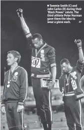  ?? AP ?? ■ Tommie Smith (C) and John Carlos (R) during their ‘Black Power’ salute. The third athlete Peter Norman gave them the idea to wear a glove each.