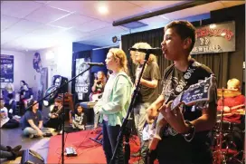  ?? Courtesy photo ?? Santa Clarita School of Rock students perform a Glam Rock set at Vincenzo’s Pizza in Newhall. A total of 25 students in the School of Rock’s Performanc­e and Rock 101 programs will take the stage Jan. 19 to perform a special set from their “Glam Rock”...