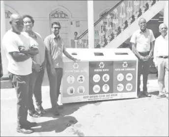  ??  ?? Georgetown Mayor and City Council officials stand with their new recycling bin. From left are Mark Griffith (Councillor), Sherry Jerrick (Town Clerk), Mayor Ubraj Narine, Deputy Mayor Alfred Mentore and Dr. Carl Niamatalli.