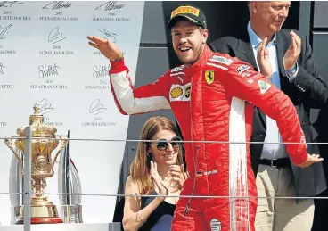  ?? /Reuters ?? Trophy time: Sebastian Vettel celebrates beating home favourite Lewis Hamilton to win the British Grand Prix on Sunday.