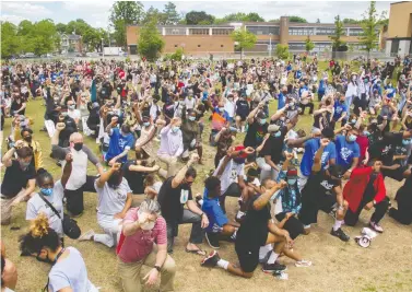  ?? JOHN KENNEY FILES ?? People raise their arms at an event called Montreal Kneels for Change at Loyola park last summer. “More and more other people are coming forward to stand in solidarity with the Black community,” Fariha Naqvi-mohamed writes.