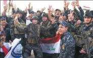  ?? FADEL SENNA/ AFP ?? Iraqi forces celebrate in the Old City of Mosul on Monday after the government announced the liberation of the embattled city from Islamic State control.