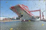  ?? REUTERS ?? China's first domestical­ly built aircraft carrier during its launching ceremony in Dalian, Liaoning province on Wednesday.