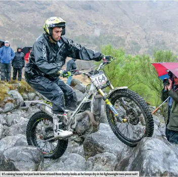  ??  ?? It’s raining heavy but just look how relaxed Ross Danby looks as he keeps dry in his lightweigh­t two-piece suit!