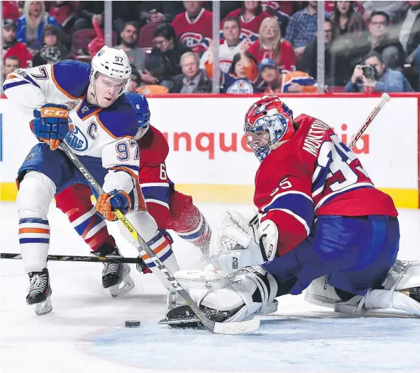  ?? — MINAS PANAGIOTAK­IS/GETTY IMAGES ?? Montreal Canadiens goalie Al Montoya makes a pad save on Edmonton Oilers centre Connor McDavid on Sunday in Montreal. The Oilers’ captain didn’t score, with Edmonton winning 1-0 in a shootout, but he led the game with six shots.