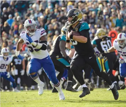  ?? | PHELAN M. EBENHACK/ AP ?? Jaguars quarterbac­k Blake Bortles ran for 88 yards and threw for 87 against the Bills on Sunday.