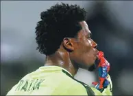  ?? AMR ABDALLAH DALSH / REUTERS ?? Ghana’s Brimah Razak kisses a super hero action figure before the African Cup of Nations semifinal at Stade de Francevill­e in Gabon on Thursday. There was no super help forthcomin­g, as unheralded Cameroon went on to win 2-0.
