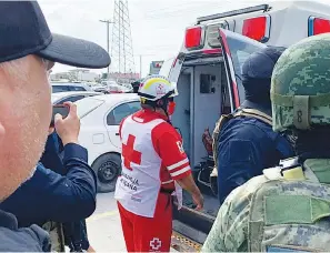  ?? (AP Photo) ?? A Red Cross worker closes the door of an ambulance carrying two Americans found alive after their abduction in Mexico last week, Tuesday in Matamoros. Two of four Americans whose abduction in Mexico was captured in a video that showed them caught in a cartel shootout have been found dead, officials said Tuesday. The two surviving Americans were taken to the border near Brownsvill­e, Texas, in a convoy of Mexican ambulances and SUVs.