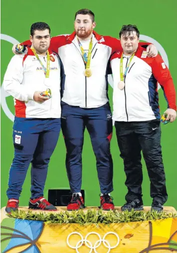  ?? Foto: dpa ?? Die Medailleng­ewinner der Gewichtheb­er von Rio: Lasha Talakhadze aus Georgien (Gold), Gor Minasyan aus Armenien (Silber) und Irakli Turmanidze aus Georgien (Bronze) – Stand heute. Gut möglich, dass ein bis drei der hier abgebildet­en Sportler in den...