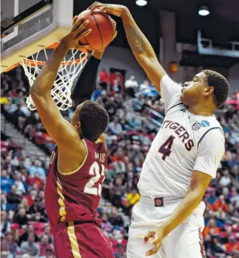  ?? THE ASSOCIATED PRESS ?? Auburn forward Chuma Okeke, right, blocks a shot by Charleston forward Nick Harris during the first half Friday in San Diego. The Tigers held on to win the NCAA tournament round-of-64 game 62-58.