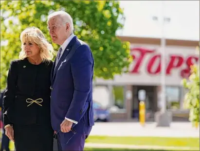  ?? Andrew Harnik / Associated Press ?? President Joe Biden and first lady Jill Biden on Tuesday visit the scene of a shooting at a supermarke­t to pay respects and speak to families of the victims of Saturday’s shooting in Buffalo.