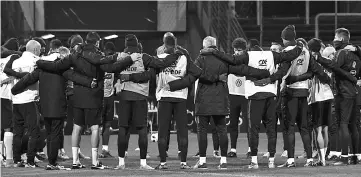  ?? - AFP photo ?? The French team stand for a minute of silence to pay tribute to the victims of the Paris attacks during a training session on the eve of the friendly match Germany v France on November 13, 2017 in Cologne, western Germany.