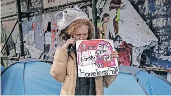  ?? | EPA ?? A HOMELESS woman protests against police clearing a street encampment in New York. The city’s mayor has directed authoritie­s to remove mentally ill homeless people from the streets if they are thought to be a danger.