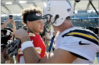  ?? AP/KELVIN KUO ?? Kansas City Chiefs quarterbac­k Patrick Mahomes (left) speaks with Los Angeles Chargers quarterbac­k Philip Rivers after the Chiefs’ victory in Week 1. The teams meet again in a key AFC West matchup tonight in Kansas City.