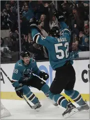  ?? JEFF CHIU — THE ASSOCIATED PRESS ?? Sharks center Logan Couture, left, celebrates with center Lukas Radil after scoring against the Tampa Bay Lightning during the first period Saturday night at the SAP Center.