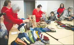  ?? BEA AHBECK/NEWS-SENTINEL ?? Members of the Loel Center Knitting Group, including Amy Morita, of Lodi, far left, pack up the hats they are donating as they meet to work on knitting hats for veterans in a Christmas Gift Program, which they presented to the American Legion Auxiliary...