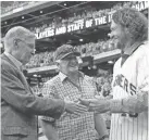  ?? MORRY GASH / ASSOCIATED PRESS ?? Former baseball commission­er Bud Selig and radio announcer Bob Uecker shake hands with former Milwaukee Brewers great Robin Yount before a baseball game Saturday in Milwaukee.