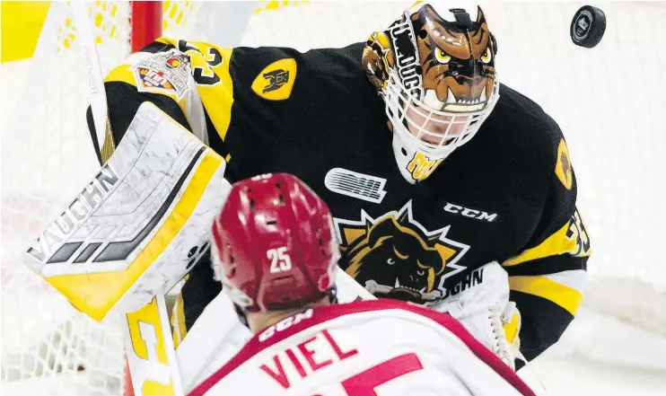  ??  ?? OHL Hamilton Bulldogs goalie Kaden Fulcher stops a shot from QMJHL Acadie-Bathurst Titan forward Jeffrey Truchon-Viel in Regina on Tuesday. — THE CANADIAN PRESS