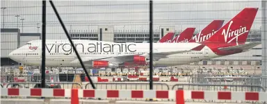  ??  ?? Virgin Atlantic planes are pictured at the apron at Manchester Airport in north-west England on June 8.