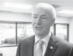  ?? Associated Press ?? Arkansas Gov. Asa Hutchinson speaks to reporters Jan. 9 in Little Rock about his proposed budget for the coming fiscal year. The Republican governor has proposed adding a work requiremen­t to the state's hybrid Medicaid expansion. GOP leaders from...