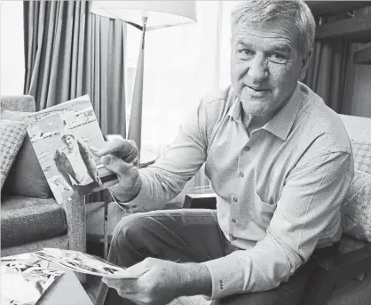  ?? COURTESY OF KELSEY WILSON ?? Bobby Orr looks through photos from the Toronto Star archives during an interview for his new book, “Bobby: My Life in Pictures.”