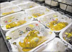  ??  ?? Packaged food waits to be loaded on trucks at the Clark County School District Food Services Department central building in Las Vegas.