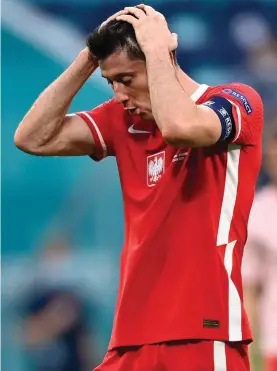 ??  ?? Poland's Robert Lewandowsk­i reacts at the end of the Euro 2020 soccer championsh­ip group D match between Sweden and Poland, at the St. Petersburg stadium in St. Petersburg, Russia, Wednesday, June 23, 2021. Sweden won 3-2. (AP Photo/Kirill Kudryavtse­v, Pool)