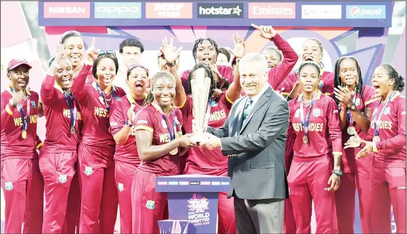  ??  ?? ICC Chief Zaheer Abbas (center right), presents the trophy to West Indies Stafanie Taylor (center left) after West Indies won the World T20 cricket tournament women’s final match between Australia and West Indies at the Eden Gardens Cricket Stadium in...