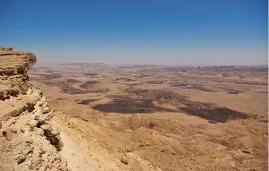  ??  ?? ABOVE: The Negev seen from Mitzpe Ramon. ABOVE: Bible pages weighed down with rocks. OPPOSITE: Oliver McAfee.