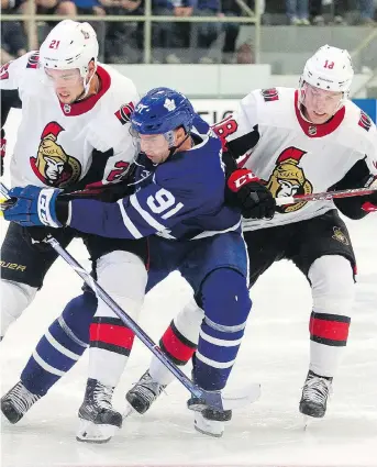  ?? THE CANADIAN PRESS ?? Logan Brown and Ryan Dzingel of the Senators put the squeeze on Toronto’s John Tavares during pre-season action on Tuesday night in Lucan. Tavares still managed to score twice in a 4-1 Leafs win.