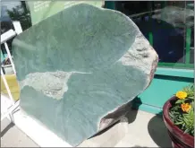  ?? Facebook ?? Owners of Cariboo Jade and Gifts in Cache Creek say this piece of jade, left, was stolen on the weekend by someone driving the truck and orange excavator, right.
