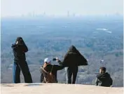  ?? CURTIS COMPTON ?? In his “I Have A Dream” speech, Martin Luther King spoke of a symbolic bell of freedom ringing from the tops of Stone Mountain to the hills of Tennessee. Visitors can climb the steep trail to enjoy the summit views of the Atlanta skyline.