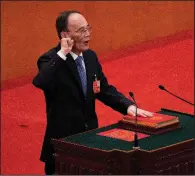  ?? AP/ANDY WONG ?? Wang Qishan, shown taking the oath of office Saturday after being elected China’s vice president, is expected to have more influence than past vice presidents have had, including in helping manage U.S.-China relations.