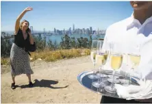  ?? Paul Chinn / The Chronicle ?? A waiter serves refreshmen­ts to guests at a groundbrea­king ceremony for the constructi­on of 266 Yerba Buena residences.