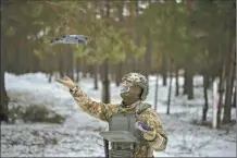  ?? AP photo ?? A Ukrainian serviceman lands a drone during a demonstrat­ion close to the border with Belarus, Ukraine on Wednesday. Reconnaiss­ance drones fly several times a day from Ukrainian positions across the border into Belarus, a close Russian ally, scouring for signs of trouble on the other side.