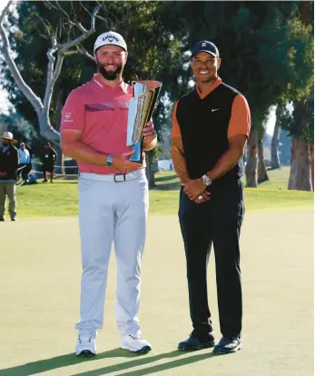  ?? RYAN KANG/AP ?? Jon Rahm and Tiger Woods pose for photos Sunday after Rahm’s victory at the Genesis Invitation­al in Los Angeles. The 47-yearold Woods was the tournament host and made his season debut in the event, finishing in a tied for 45th.