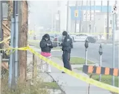  ?? CATHIE COWARD/HAMILTON SPECTATOR ?? Police speak to a resident along Sanford Avenue in Hamilton where the street was closed from Main Street East to Cannon Street for a homicide investigat­ion. Yosif Al-Hasnawi, 19, the oldest of five children and a firstyear Brock University student was...